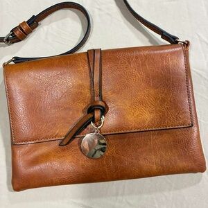 Classic Tan Leather Crossbody Bag with Polished Charm